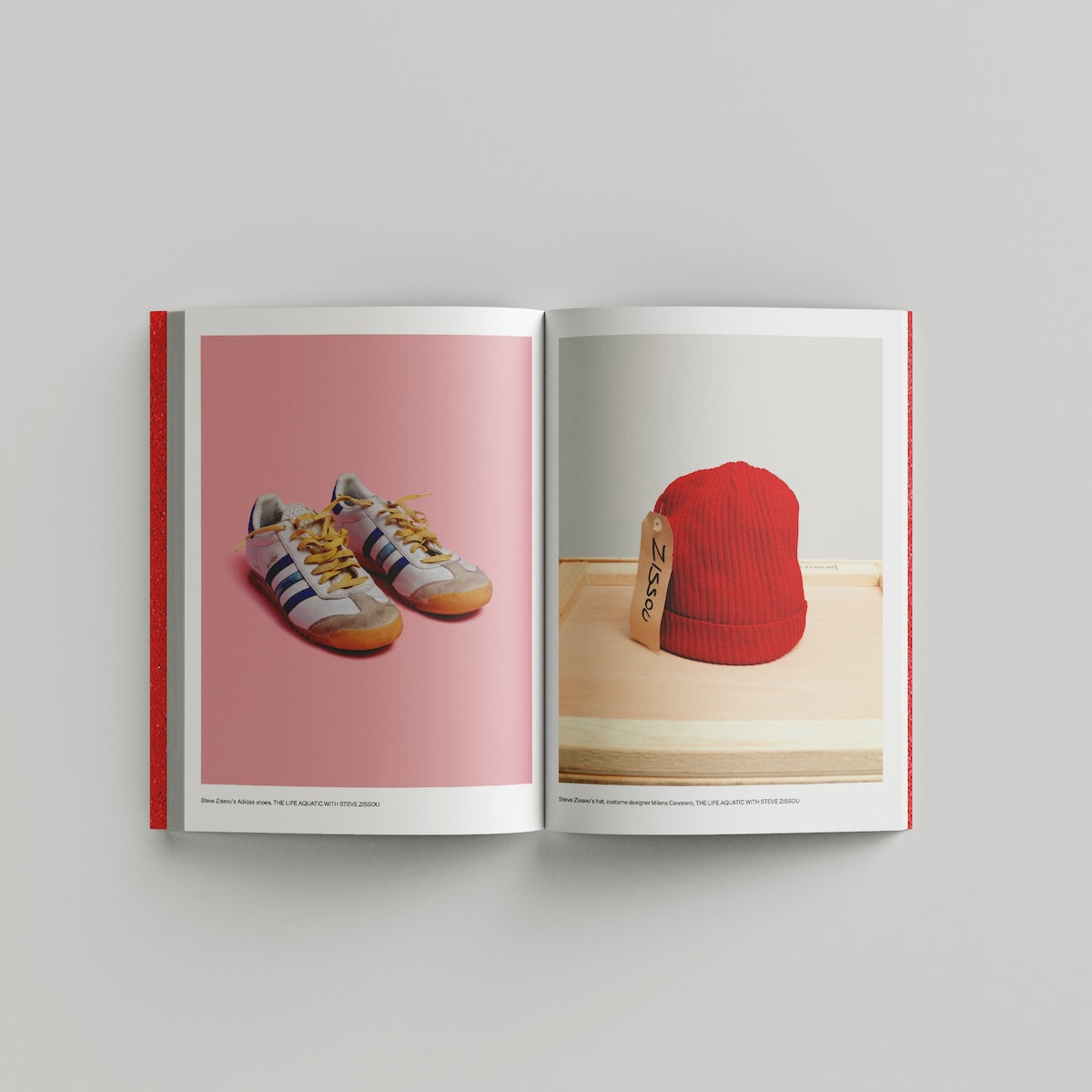 Open page of Wes Anderson catalogue displaying images of sneakers and a red beanie.