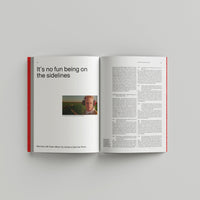 Open page of Wes Anderson catalogue displaying  a gray background with text and a photo of Owen Wilson.