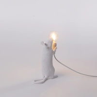 White mouse-shaped lamp holding a light bulb on a white background