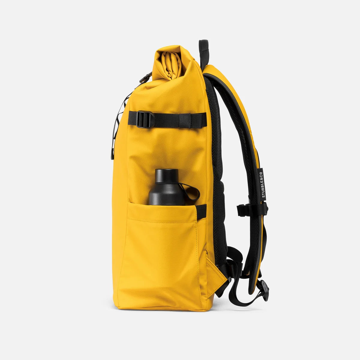 A yellow roll-top backpack with black straps, a side pocket holding a black bottle, against a light gray background.