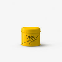 Yellow candle tin with the Design Museum and CRANBOURN, London written on the front in bold black text