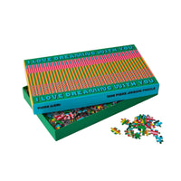 Jigsaw puzzle with colorful pieces and a decorative box on a white background