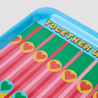 Colourful tray with heart designs and  text on a light gray background