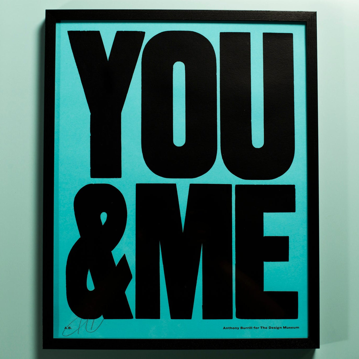 Framed artwork with 'YOU & ME' in bold black text on a light blue background