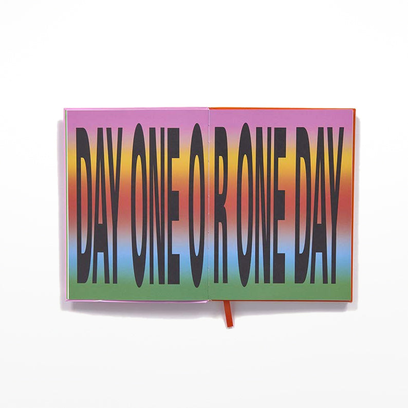 Open pages with 'day one or one day' in bold black lettering against a rainbow background