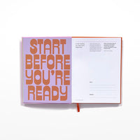 Open journal page with 'start before you're ready' in bold orange letters against a lilac background