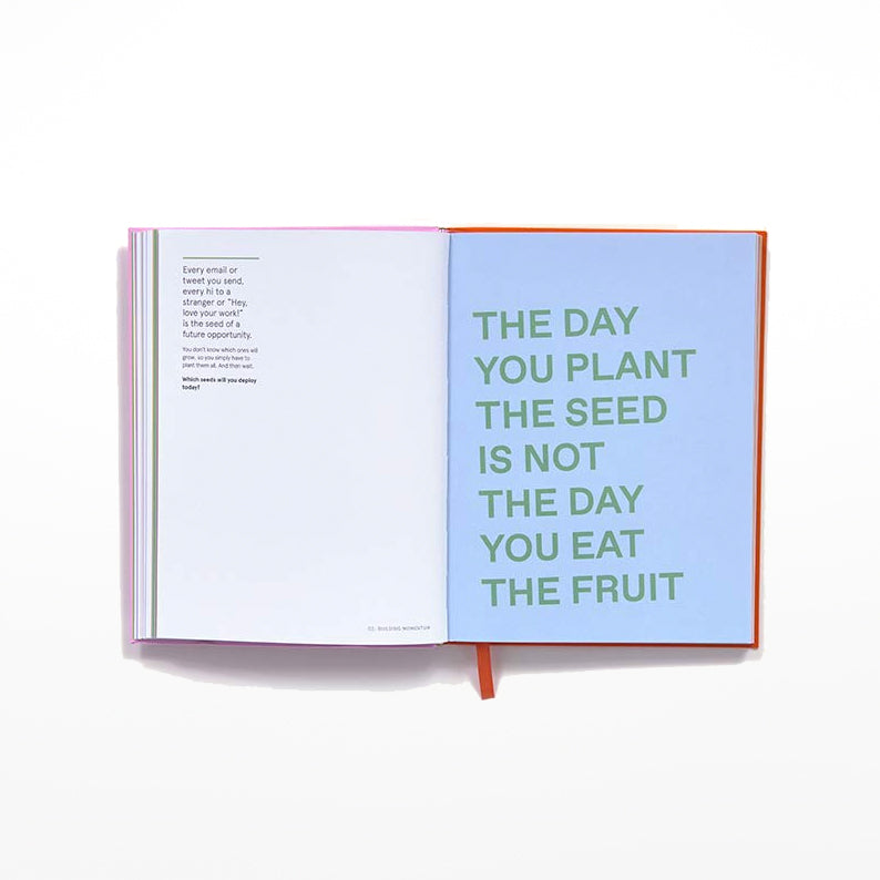 Open journal page with bold green text against a pastel blue background 