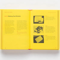 Inside page of Studio Craft with images of paper model instructions against a yellow background. 