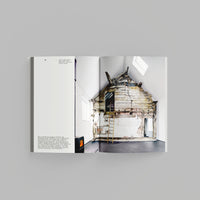 Inside page of Waste Age catalogue featuring wooden lodge inside a studio.