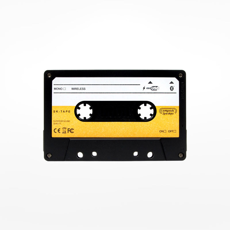 Black, white and yellow cassette style speaker on a white background